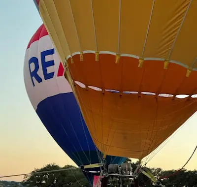 Looking up beneath a yellow hot air balloon